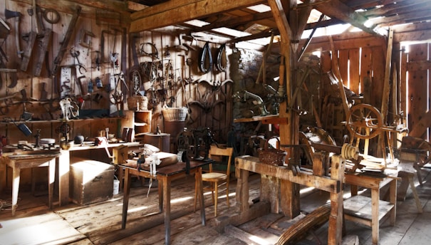 A cozy workshop corner filled with handmade crafts and tools, sunlight streaming through a window.