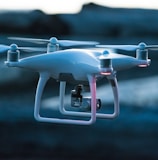 photo of white flying quadcopter