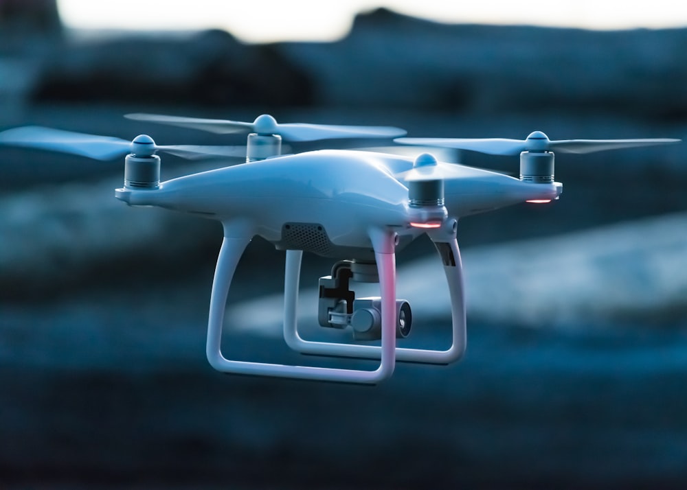 photo of white flying quadcopter