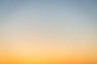 A smooth gradient shifting from pale blue to warm orange