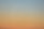 a plane flying in the sky at sunset