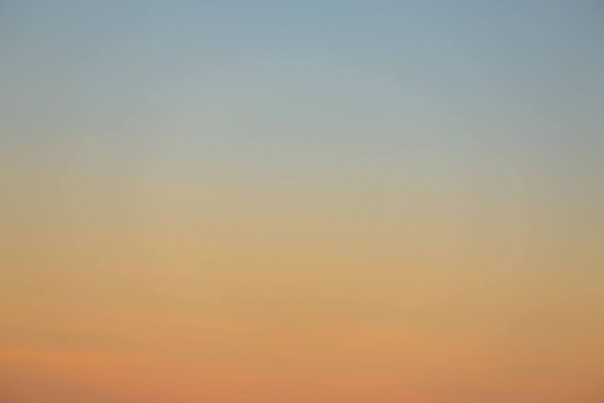 Soft pastel sky in pale pink and blue over the Aegean
