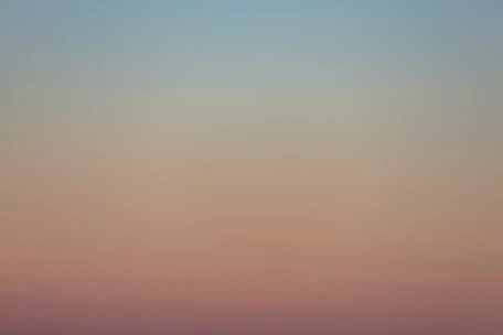 A serene space with soft peach and lavender tones, inviting calm and reflection.