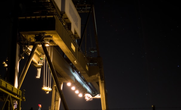 A nighttime shot of a well-lit industrial project, highlighting the precision and scale of the work.