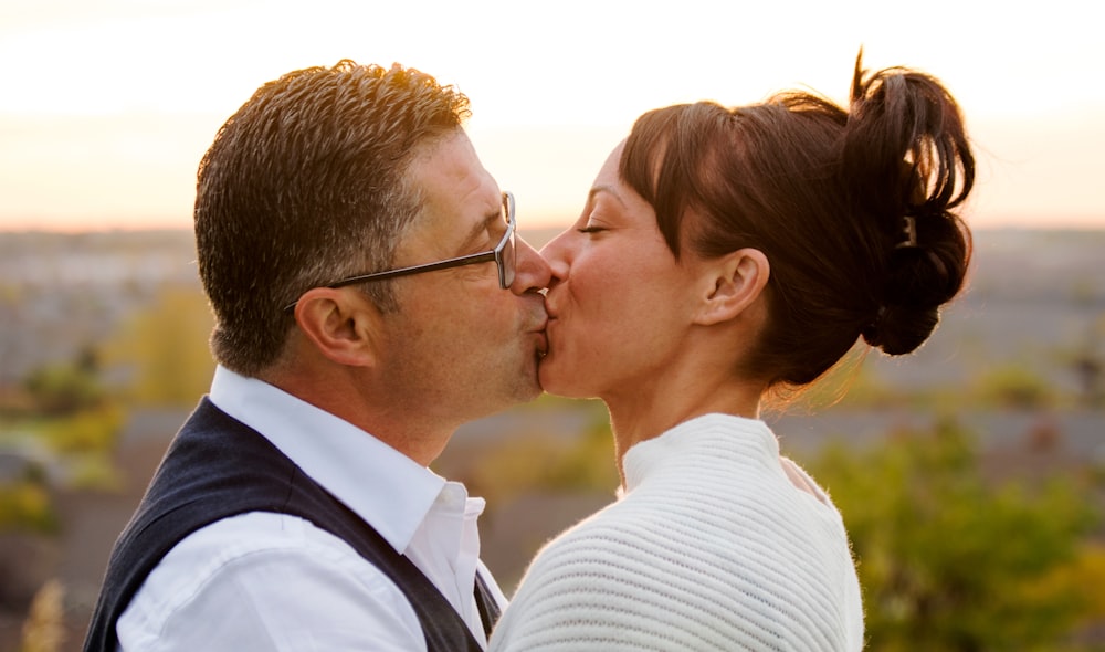 selective focus photo of woman and man kissing each other