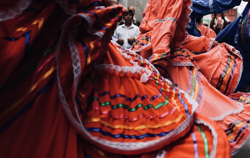 Close-up of colorful hip scarves and jingling coins during a lively dance.