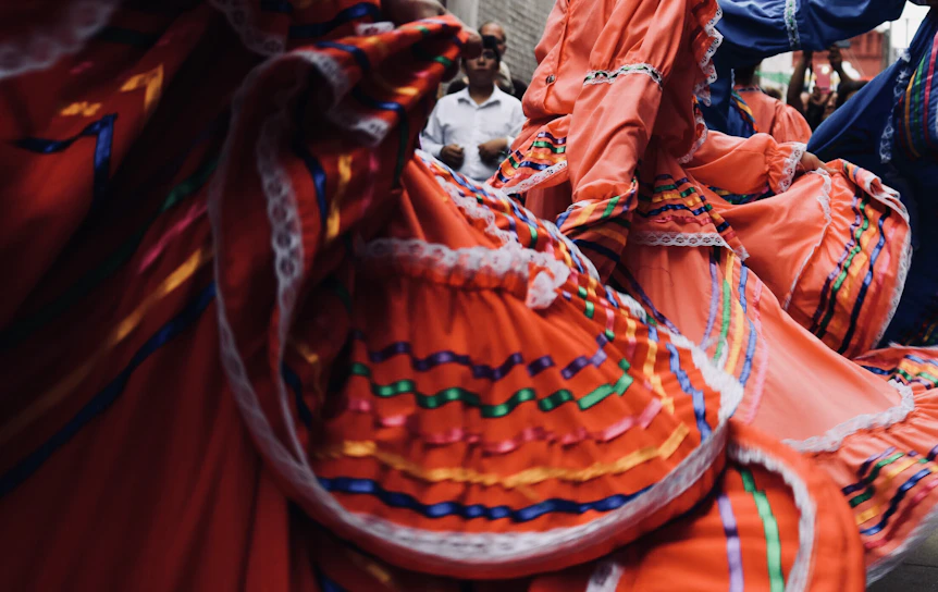 A vibrant Kurdish dance circle at a community festival, colorful traditional clothing swirling in motion.