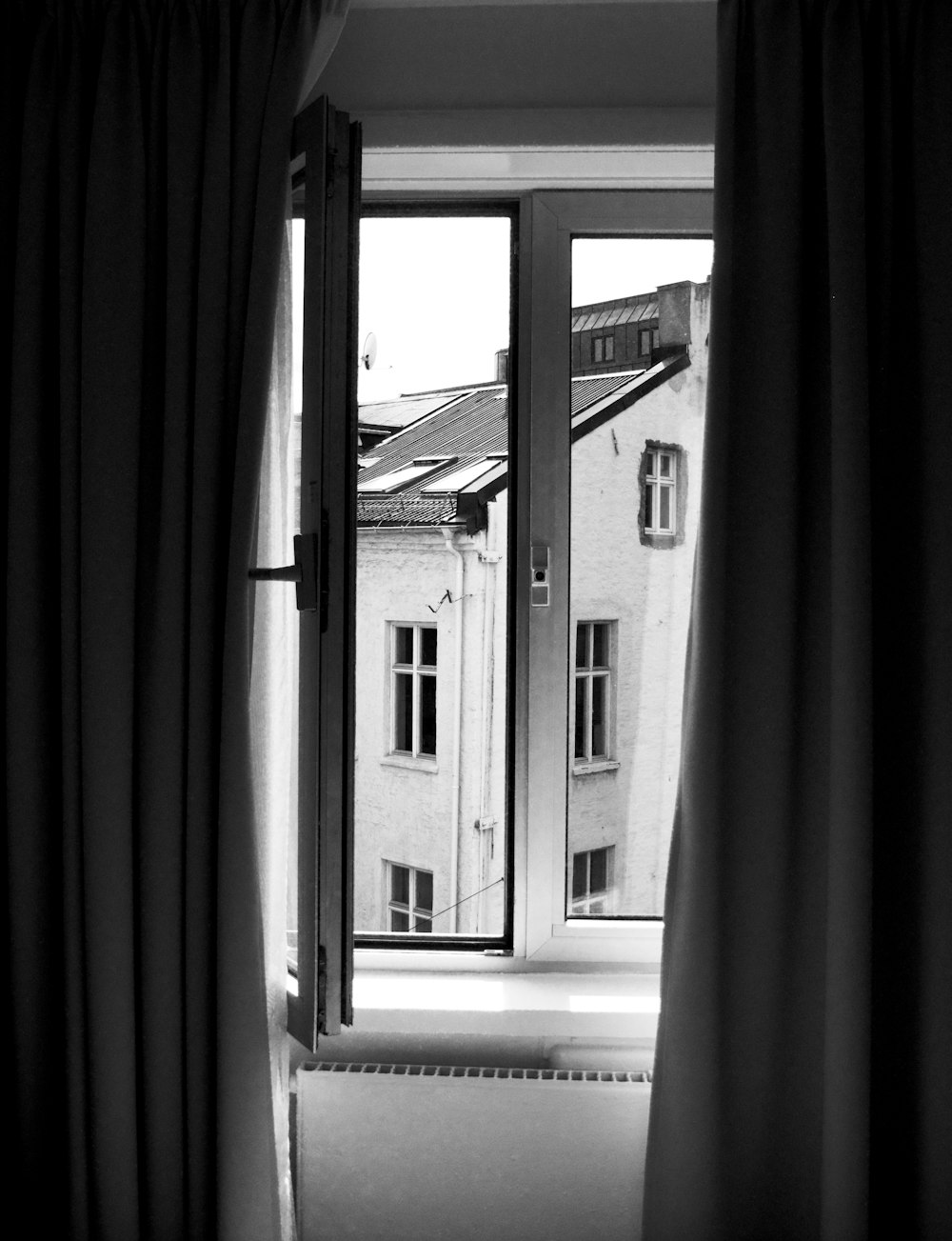 grayscale photo of wooden framed glass pane window opened