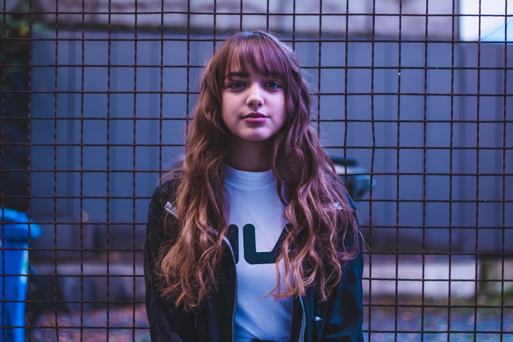 woman standing in front of black fence