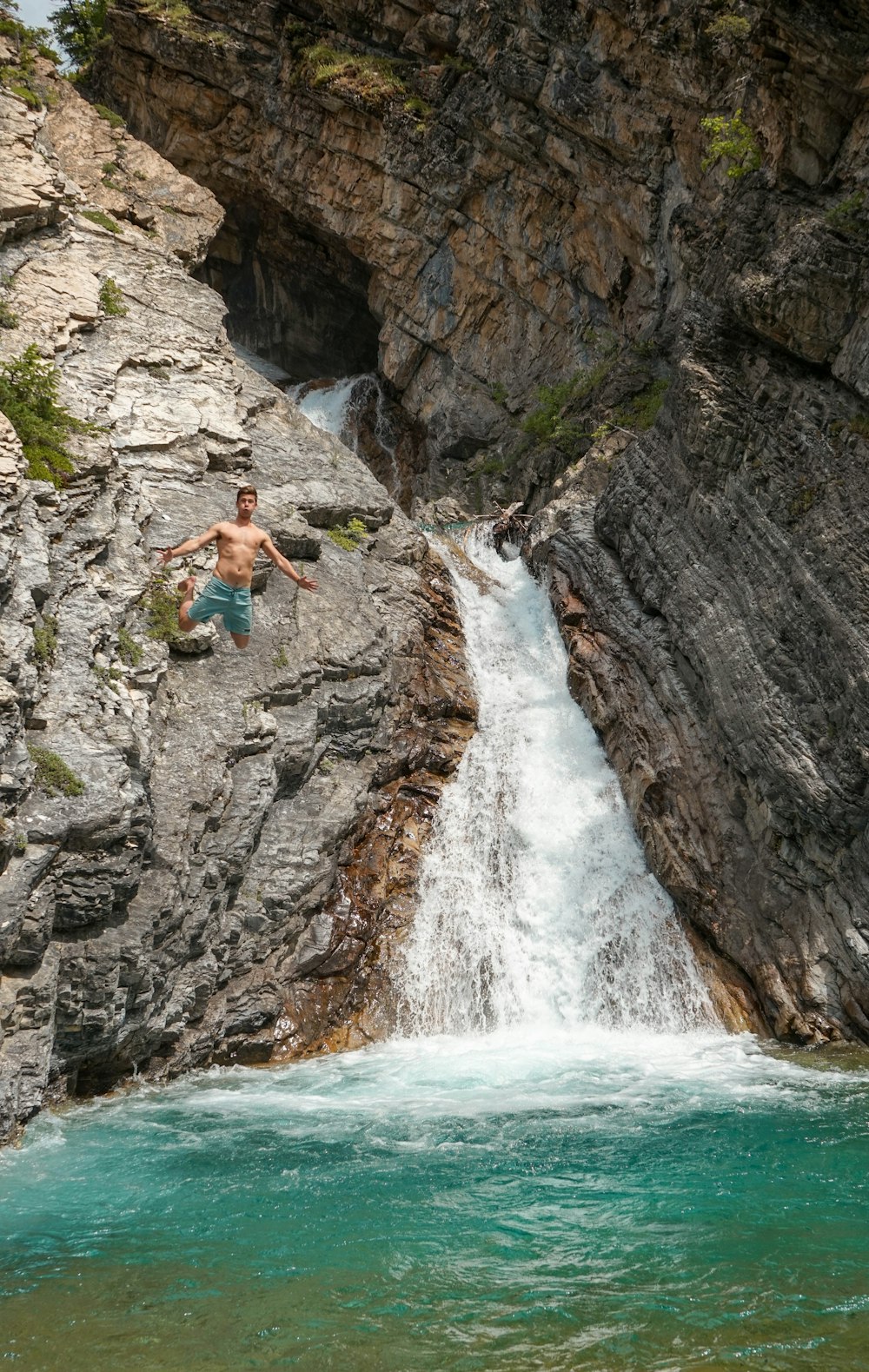 man jumping at body of water