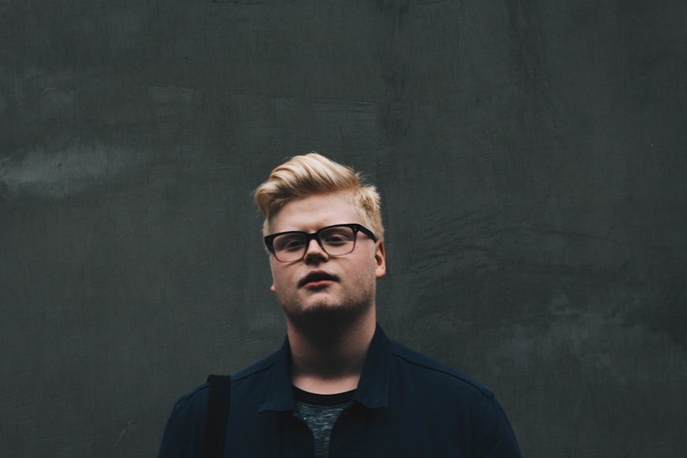 man in blue collared shirt wearing eyeglasses