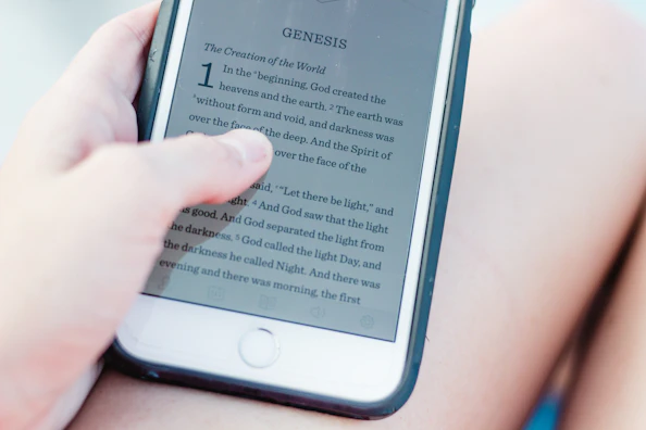 A smiling teenager reading a digital Bible story on a cozy couch with soft lighting.