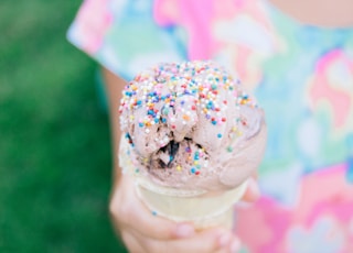 child holding an ice cream with sprinkles