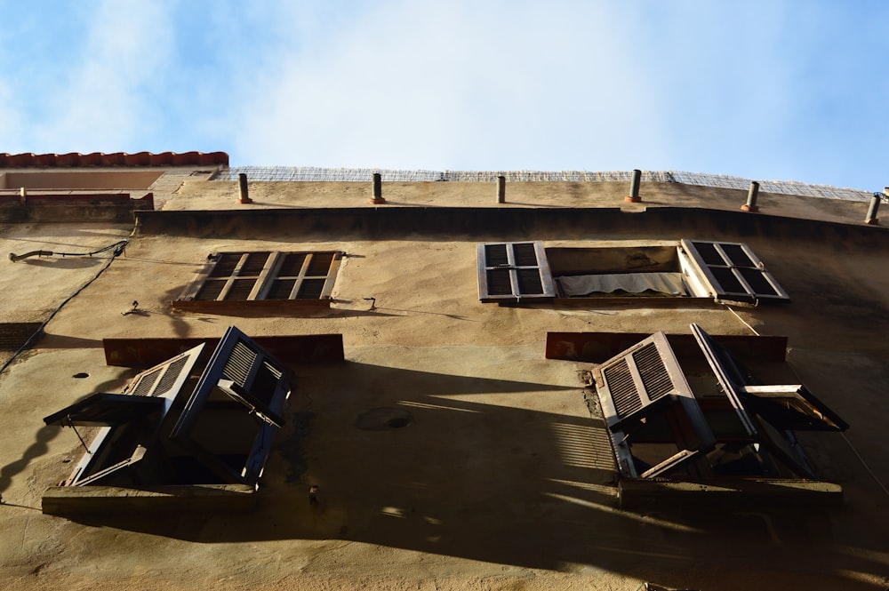 low angle photo of brown 2story house