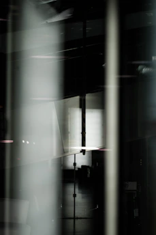 Abstract shadow play on black surface, suggesting discreet and high-status environment.