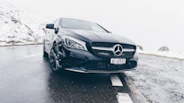 black Mercedes-Benz car on grey concrete surface