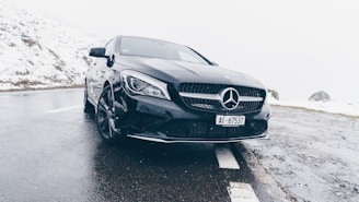 black Mercedes-Benz car on grey concrete surface