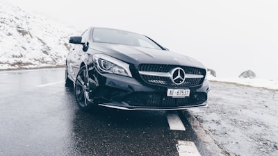 Shiny black Mercedes-Benz on a scenic mountain road
