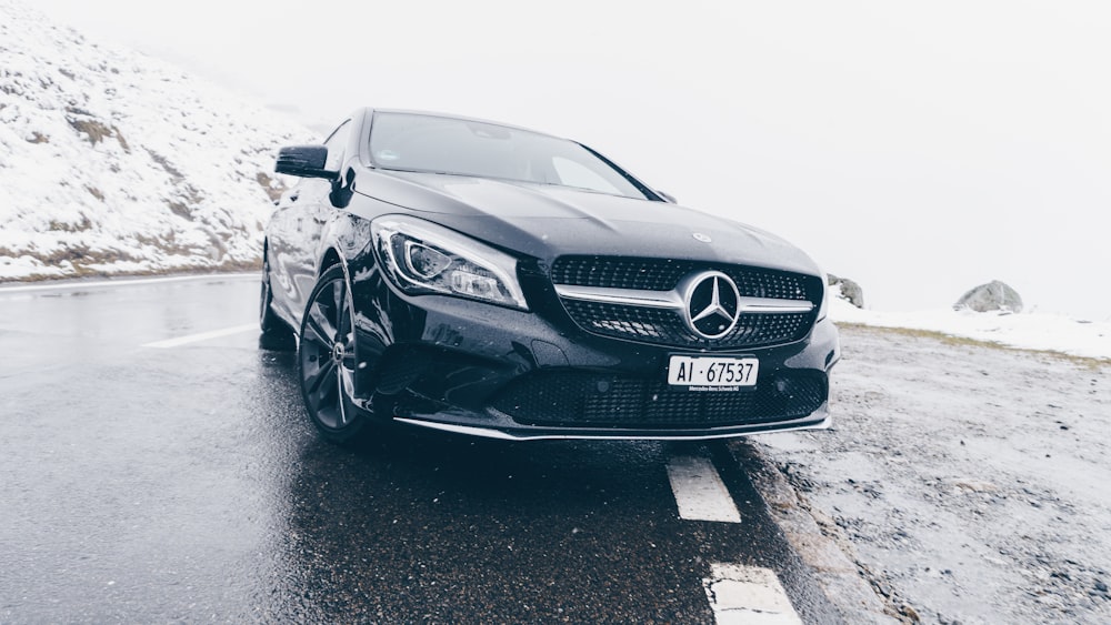 black Mercedes-Benz car on grey concrete surface