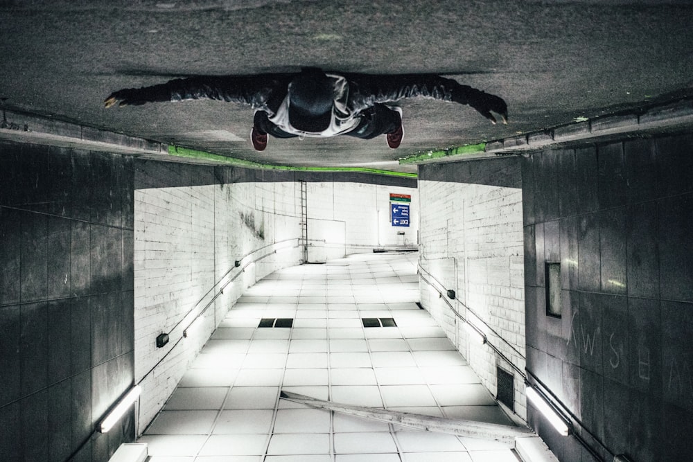 man laying on road tunnel