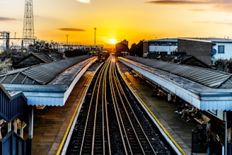 photo of brown train track at sunset