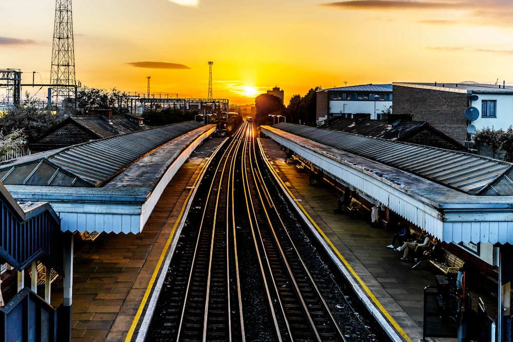 photo of brown train track at sunset