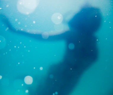 woman swimming under body of water