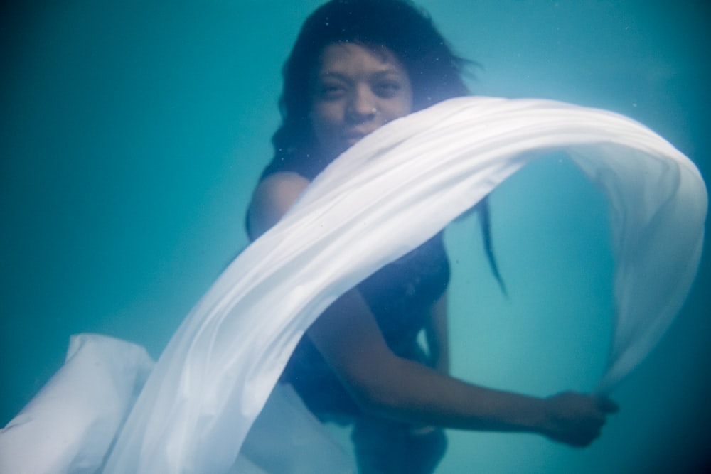 woman holding white textile underware