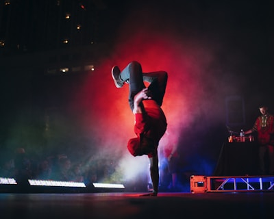 man doing breakdancing on gray surface