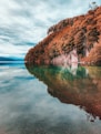 lake alps under cloudy sky at daytime