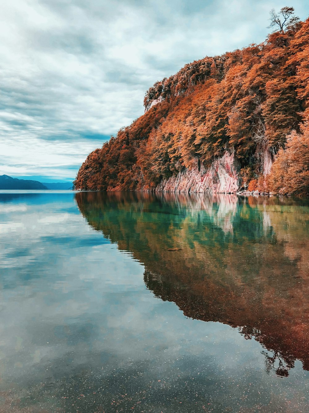 lake alps under cloudy sky at daytime