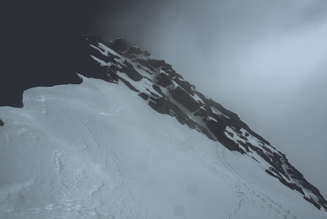 snow covered mountain under white clouds at daytime, The summit of Single Cone Peak at the Remarkables Ski Field.
