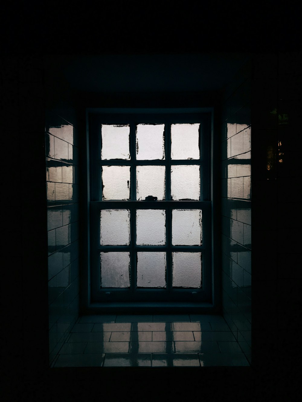 a window in a dark room with light coming through