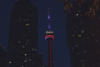 a tall building with a red, white and blue light on it's side