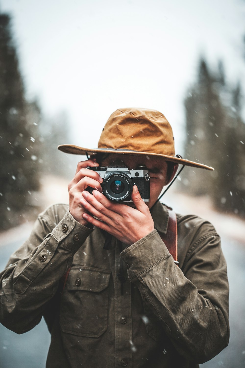 selective focus photography of man taking photo