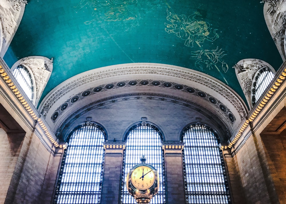 low angle of round biege clock near wall