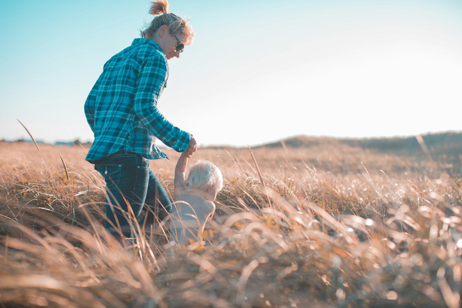 Canon EOS 5D Mark IV + Canon EF 50mm F1.2L USM sample photo. Woman holding toddler waling photography