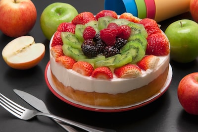 round cake with assorted fruits on top fruitcake google meet background