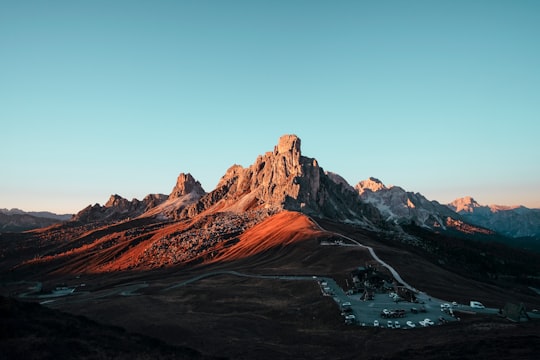 brown rock formation under blue sky in Giau Pass Italy