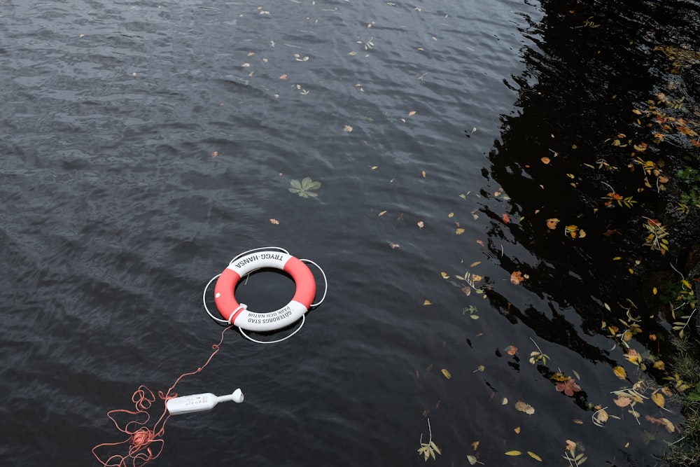 red and white bouy inflatable on water