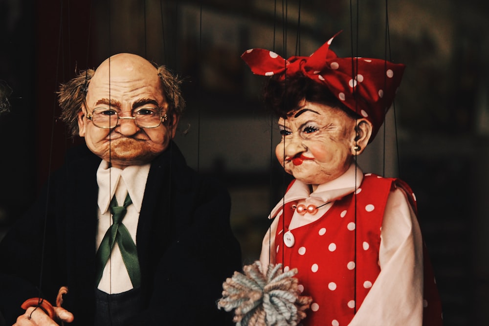 closeup photo of two man and woman puppets