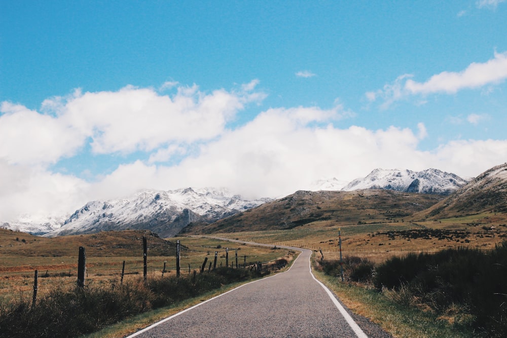 photo of gray concrete pavement heading mountain