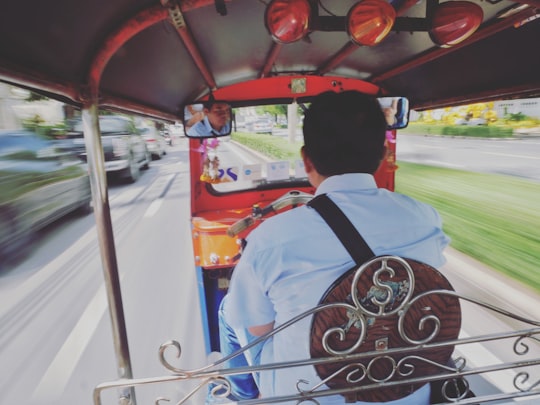 man riding auto rickshaw in Bangkok Thailand