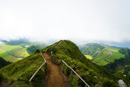 pathway in the middle of hill under cloudy sky in Miradouro da Boca do Inferno Portugal