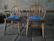 Photo of freshly upholstered farmhouse chairs in navy blue and lemon yellow fabric.