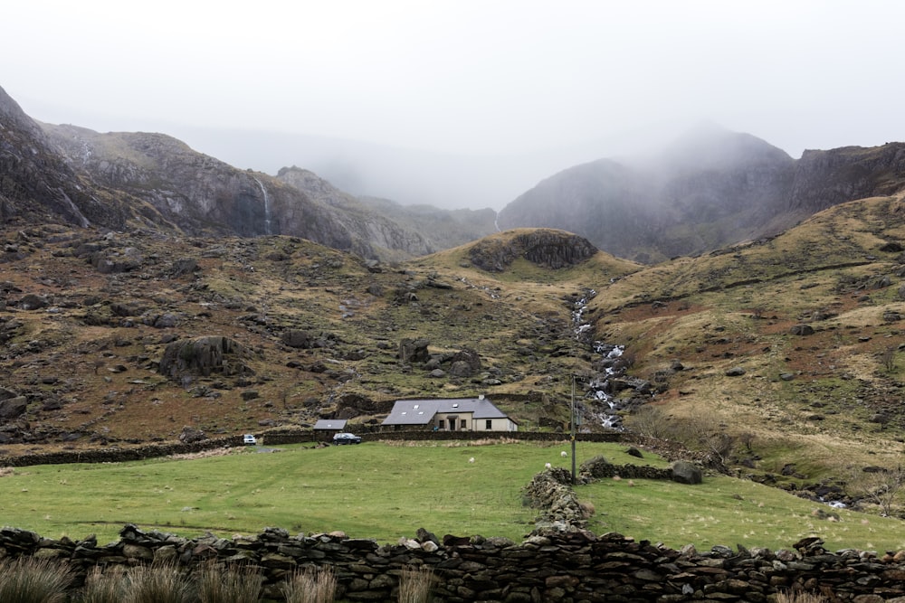 gray house surrounded with mountain