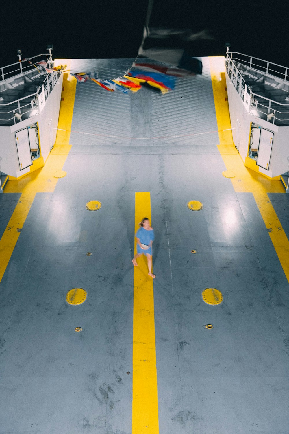 person walking in cruise deck during nighttime