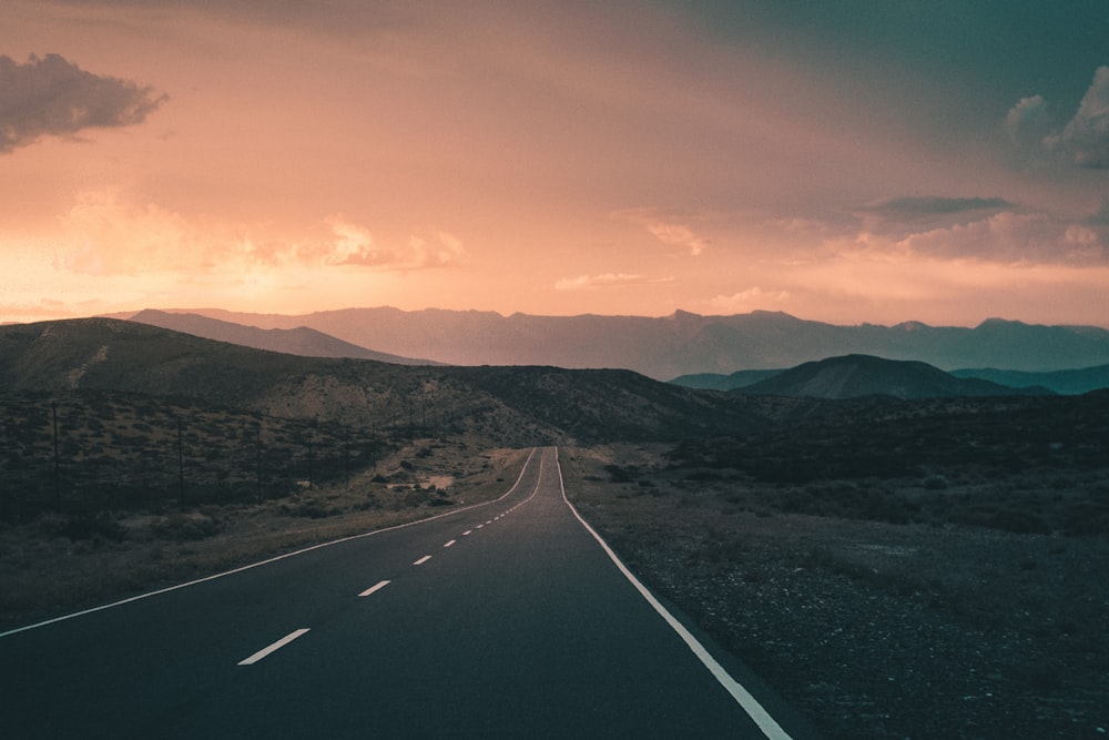 empty road pavement near the mountain photography