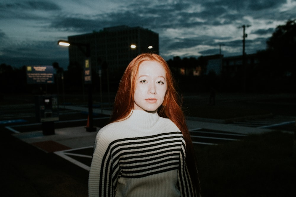 photograph of woman in black and white striped turtleneck top