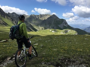 man riding bicycle on top of mountain